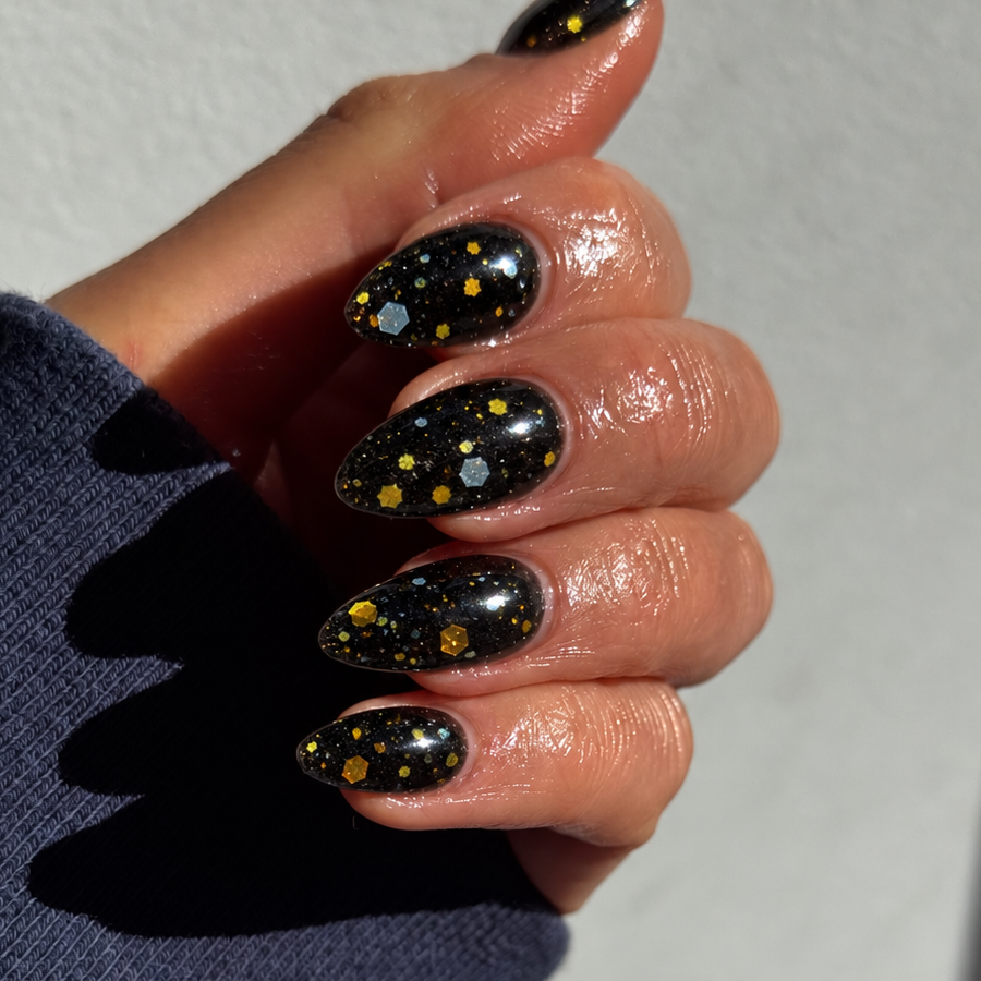 Gothic Glitter on natural nails showing black with blue and gold glitter