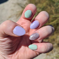 lilac love purple nails with green fields and unicorn glitter