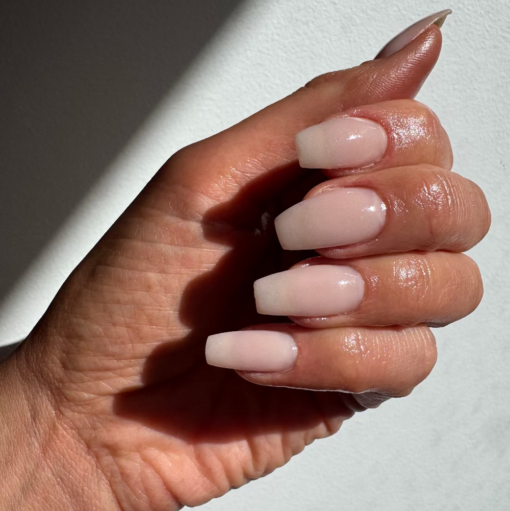 Best selling premium Nudie dip powder colour on natural nails. A semi opaque finish and high gloss manicure using DIPD Nails Pro Liquids