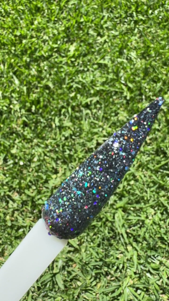 Cemetery Lane Dip Powder Glitter in the sun showing black with green flecks