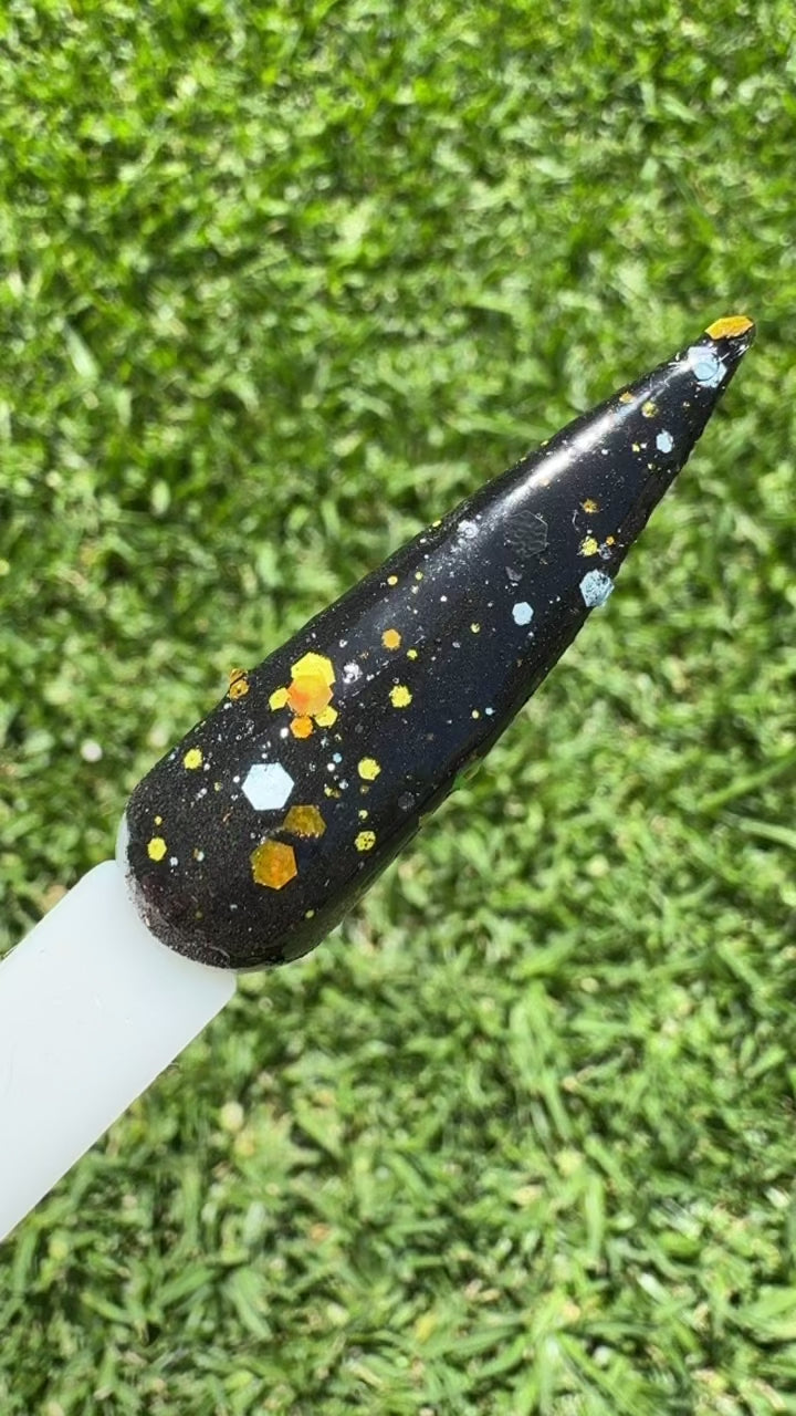 Gothic Glitter Dip Nail powder is black and glitter on a swatch video