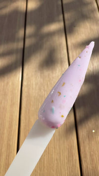 violet bloom confetti milk glitter dip powder from dipd nails on a stiletto swatch
